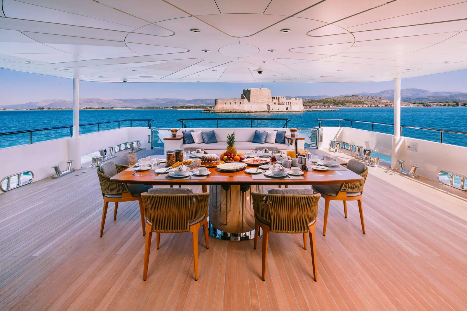 Breakfast laid on the aft deck of motor yacht Xana, facing the Bourtzi fortress at Nafplio