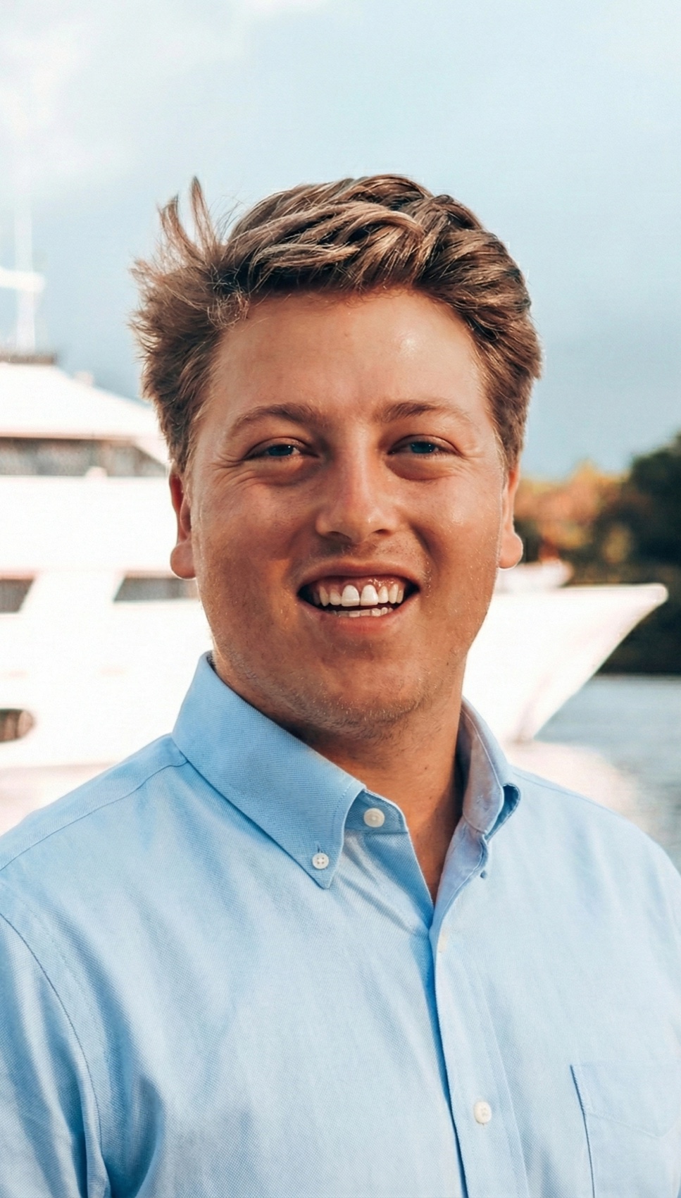 Didier Blacquiere smiling in front of a yacht